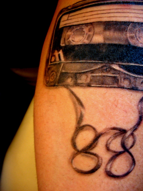 cassette tape tattoo. cassette tape with wings.